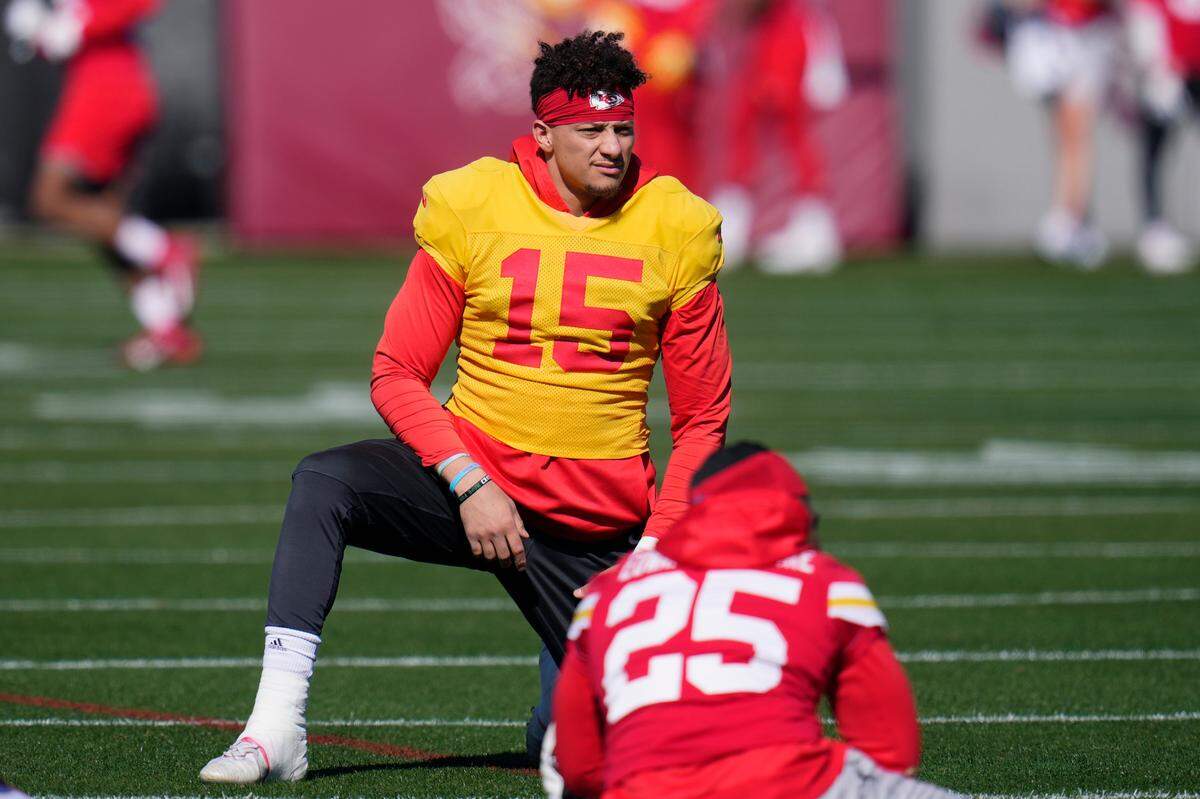 Kansas City Chiefs quarterback Patrick Mahomes (15) stretches with teammates, including running back Clyde Edwards-Helaire (25), during an NFL football practice in Tempe, Ariz., Wednesday, Feb. 8, 2023. The Chiefs will play against the Philadelphia Eagles in Super Bowl 57 on Sunday.
