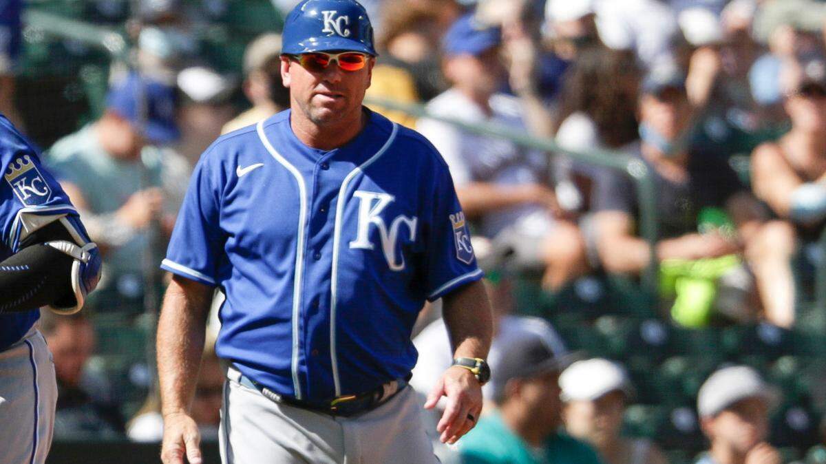Kansas City Royals’ third base coach Vance Wilson looks on as Salvador Perez rounds third base after Perez’s home run during the sixth inning of a baseball game against the Seattle Mariners, Sunday, Aug. 29, 2021, in Seattle. (AP Photo/Jason Redmond)