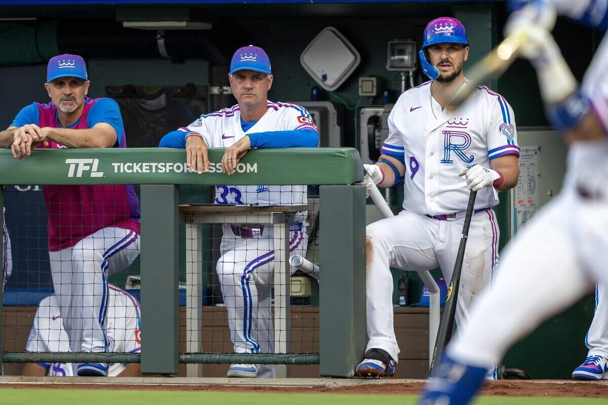 Wearing the Kansas City Royals' new "Forever Fountains" City Connect uniform, manager Matt Quatraro (33), center, watches from the dugout during the first inning of a game against the Houston Astros on Friday, June 12, 2026, at Kauffman Stadium in Kansas City.