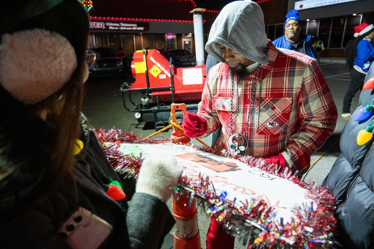 Kansas City rapper Tech N9ne signs a fan’s sign at the 12th Street lighting ceremony on Wednesday, Nov. 27, 2024.