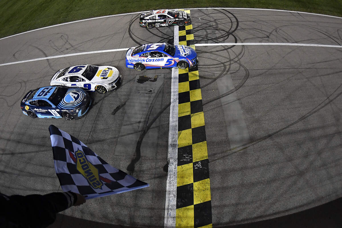 Kyle Larson, driver of the #5 HendrickCars.com Chevrolet, takes the checkered flag over Chris Buescher, driver of the #17 Castrol Edge Ford, to win the NASCAR Cup Series AdventHealth 400 at Kansas Speedway on May 5, 2024 in Kansas City, Kansas.