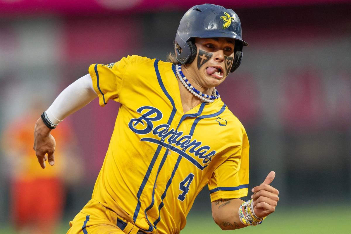 Savannah Bananas utility player KJ Jackson (4) sticks out his tongue as he runs to third base in the fifth inning of a Banana Ball game against the Firefighters at Kauffman Stadium on Friday, May 23, 2025, in Kansas City.