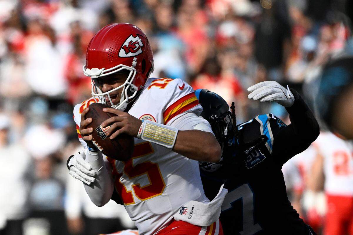 Kansas City Chiefs quarterback Patrick Mahomes (15) is sacked by Carolina Panthers linebacker Jadeveon Clowney (7) in the second quarter at Bank of America Stadium.