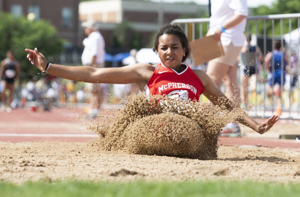 McPherson's Elle Barrett lands after competing in the Class 4A long jump during the Kansas state track and field championships at Cessna Stadium. Barrett won both the triple jump and long jump events.