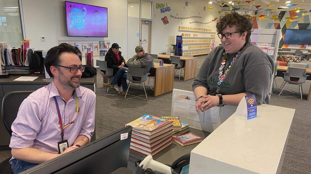 Seth Moses, Colbern Road branch manager, talks with Jordan Noland, Mid-Continent staff member, at the main desk.