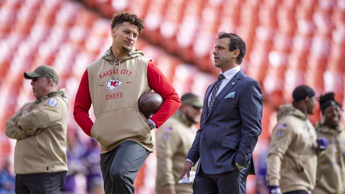 Kansas City Chiefs quarterback Patrick Mahomes warms up while chatting with Chiefs general manager Brett Veach before a game at GEHA Field at Arrowhead Stadium.