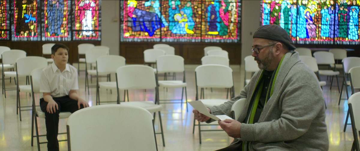 Terrick Trobough, left, and Joe Eldred in a scene from “Procession,” a documentary about six men who come together to direct a drama therapy-inspired experiment designed to collectively work through their trauma of sexual abuse.