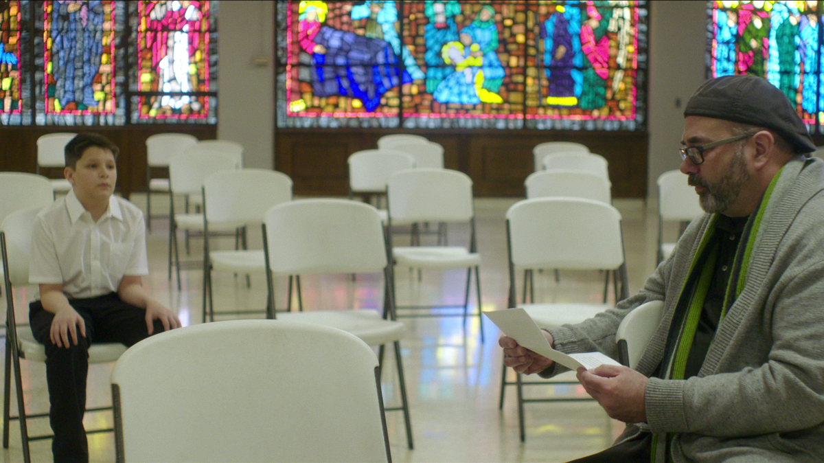 Joe Eldred, right, in a scene from “Procession,” a documentary about six men who come together to direct a drama therapy-inspired experiment designed to collectively work through their trauma of sexual abuse. Eldred accused Thomas Reardon of abuse in a 2011 lawsuit.