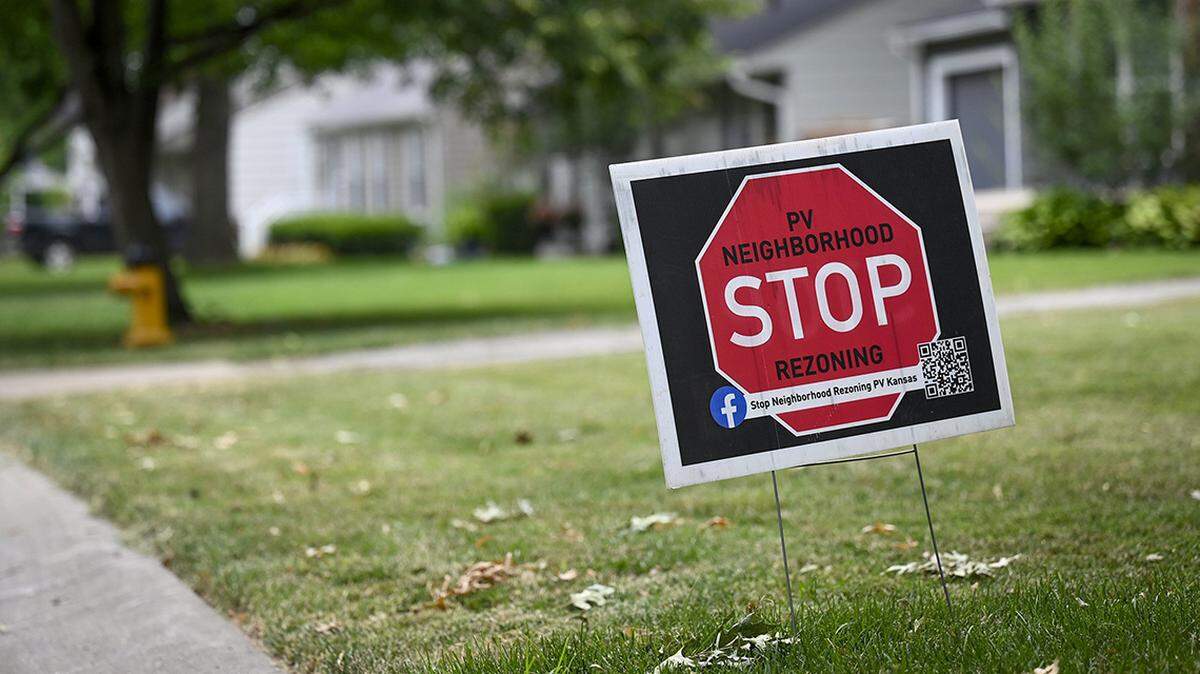 A STOP neighborhood rezoning sign is posted around Prairie Village as the residents and the city contend with the affordable housing issue in the popular neighborhood.