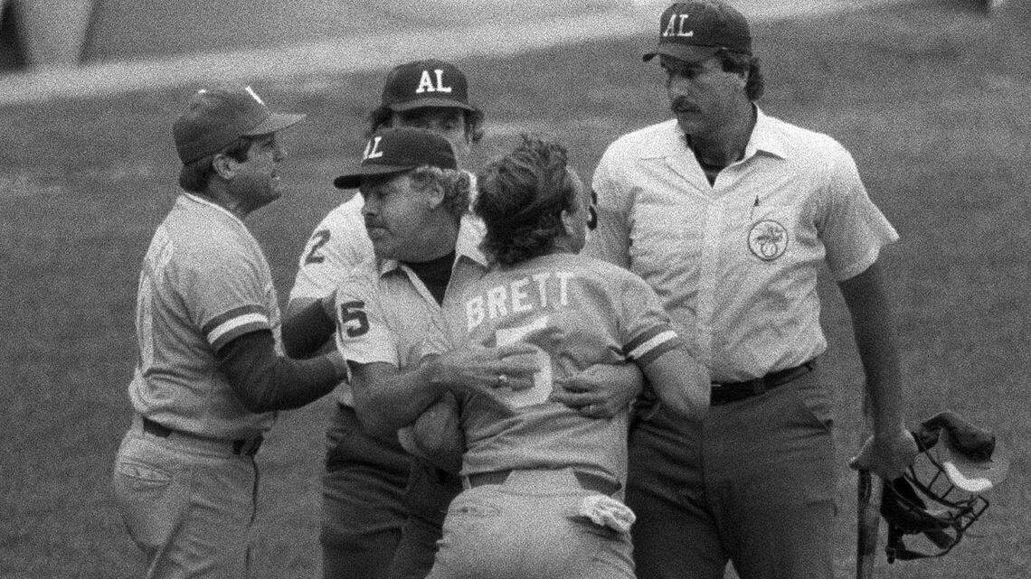 George Brett, center, is restrained by umpire Joe Brinkman after his bat, held by umpire Tim McClelland, was ruled illegal because of pine tar beyond the legal limit on the handle in this July 24, 1983 photo at Yankee Stadium.