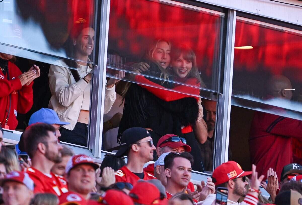Taylor Swift and Este Haim hug and Caitlin Clark claps in celebration after Travis Kelce secured a first down for the Kansas City Chiefs in the second quarter against the Los Angeles Chargers NFL regular season game at Arrowhead Stadium in Kansas City on Oct. 18, 2026.