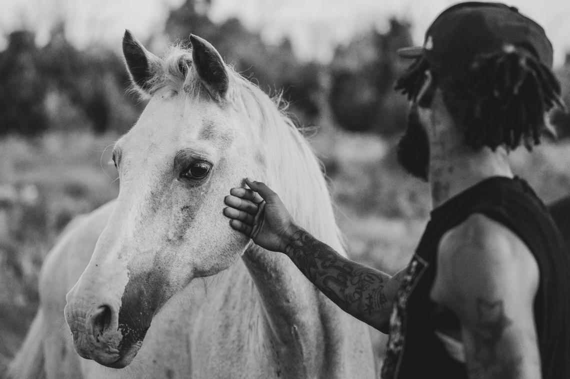 Marquise Goodwin, aka CB ‘Quis, gently strokes a mare at the Copper Boyz Ranch in Kansas City. Sitting on 88 acres, Copper Boyz Ranch is a sprawling plot of land that is home to several horses in various stages of being “broken.”