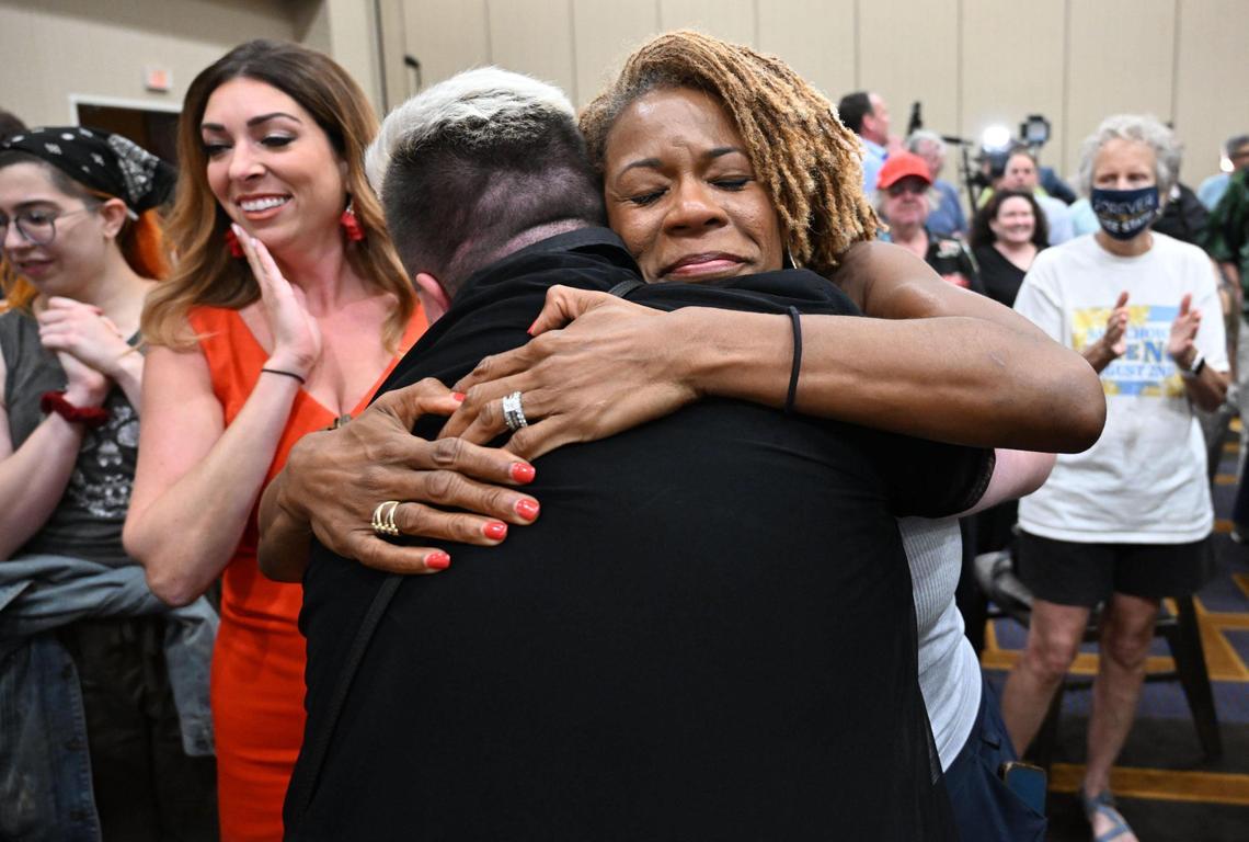 Calley Malloy, left, of Shawnee, applauded as Jae Moyer, of Overland Park, center, hugged Dawn Rattan, of Shawnee, as the Kansans for Constitutional Freedom and supporters celebrated their win during an election watch party Tuesday, August 2, 2022, at the Overland Park Convention Center, 6000 College Blvd. The group backed a ‘No’ vote on the constitutional amendment, which if passed, removes the right to an abortion from the Kansas constitution. Moyer is President of the LGBTQ Democractic Caucus.
