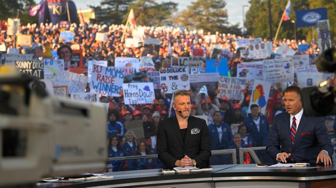 ESPN’s GameDay hosts from left, Pat McAfee, and Kirk Herbstreit prepared to broadcast from the University of Kansas campus in Lawrence on Saturday, Oct. 8, 2022, on a stage set up on Campanile Hill.