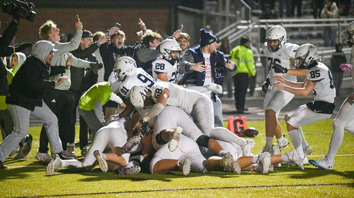 Mill Valley celebrates the winning touchdown as time expires Friday night, sending the Jaguars to the Kansas Class 5A state championship game.