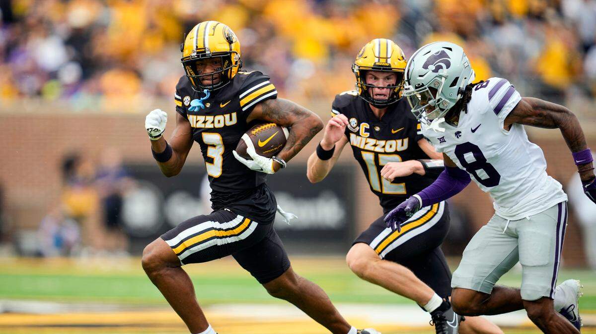 Missouri Tigers wide receiver Luther Burden III, left, runs with the ball as Kansas State Wildcats cornerback Will Lee III pursues during a game at Faurot Field in Columbia on Sept. 16, 2023.