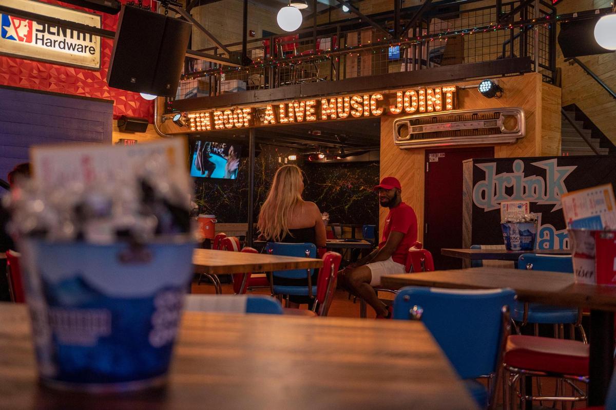 Customers wait for their orders in the indoor seating area at Tin Roof.