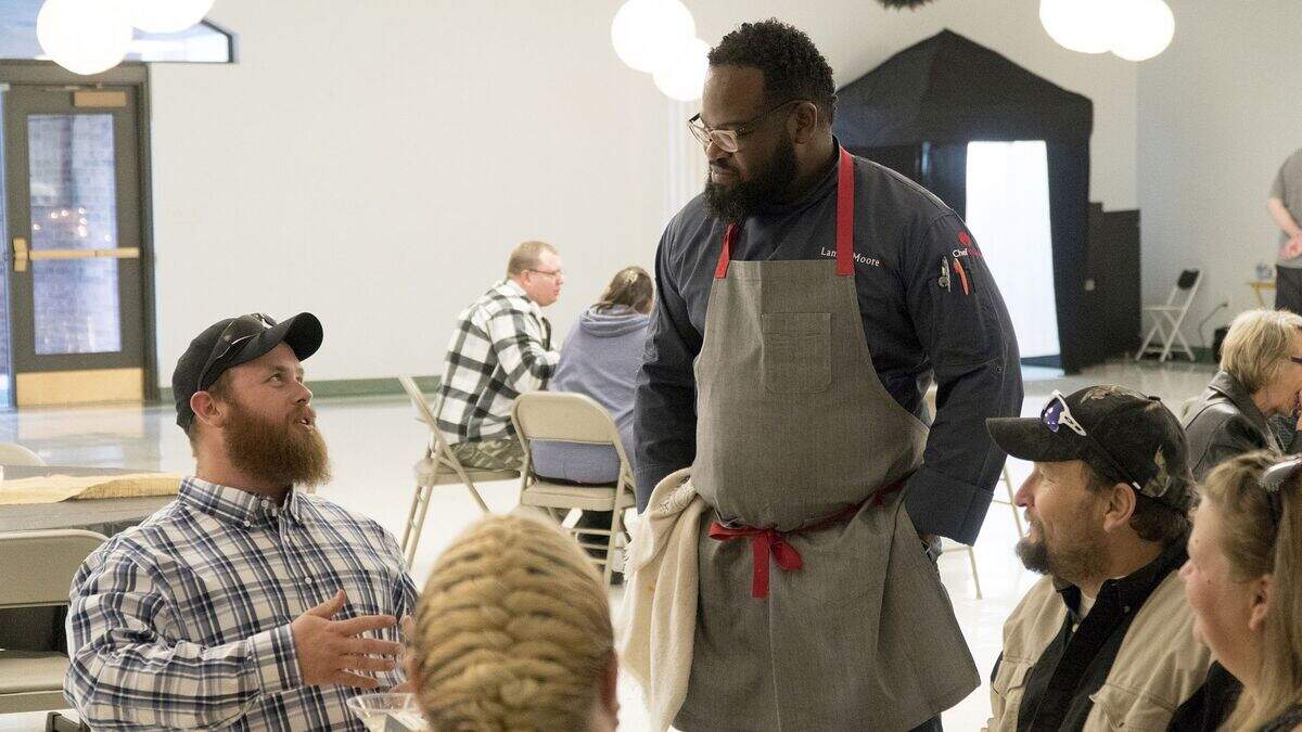 Chicago chef Lamar Moore, center, was paired with a Waverly food truck owner and former pig farmer Doug Henry (not pictured).