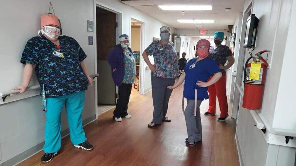 Workers at Jefferson Healthcare in Lee’s Summit model some of the finished masks from One Mask at a Time.