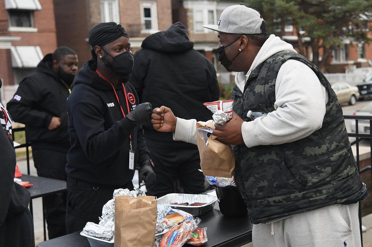 Goodbrother J.D. greets Broderick Gist, of St. Louis, at a site where the “Serving Our Streets” initiative offers resources including overdose medicine and mental health education. The services help build trust in the community and support efforts to prevent gun violence.