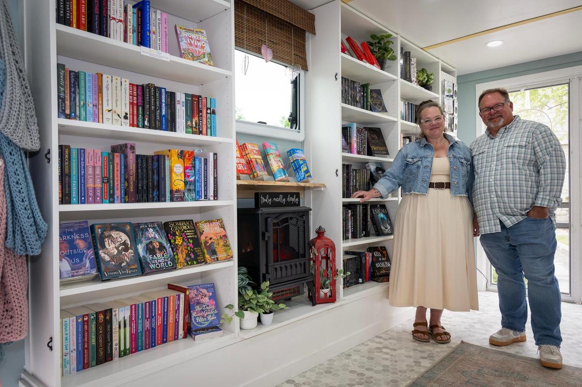 Kara and Damien Bowersock of Smitten Booktique inside their mobile bookstore housed in a 20-foot cargo trailer on May 20, 2025, in Overland Park. 