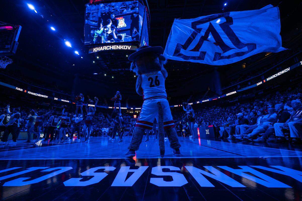 Arizona Wildcats mascot Wilbur waves an Arizona flag during player introductions before the start of the Big 12 Men's Basketball Tournament Championship game between Arizona and the Houston Cougars at T-Mobile Center on Saturday, March 14, 2026, in Kansas City.
