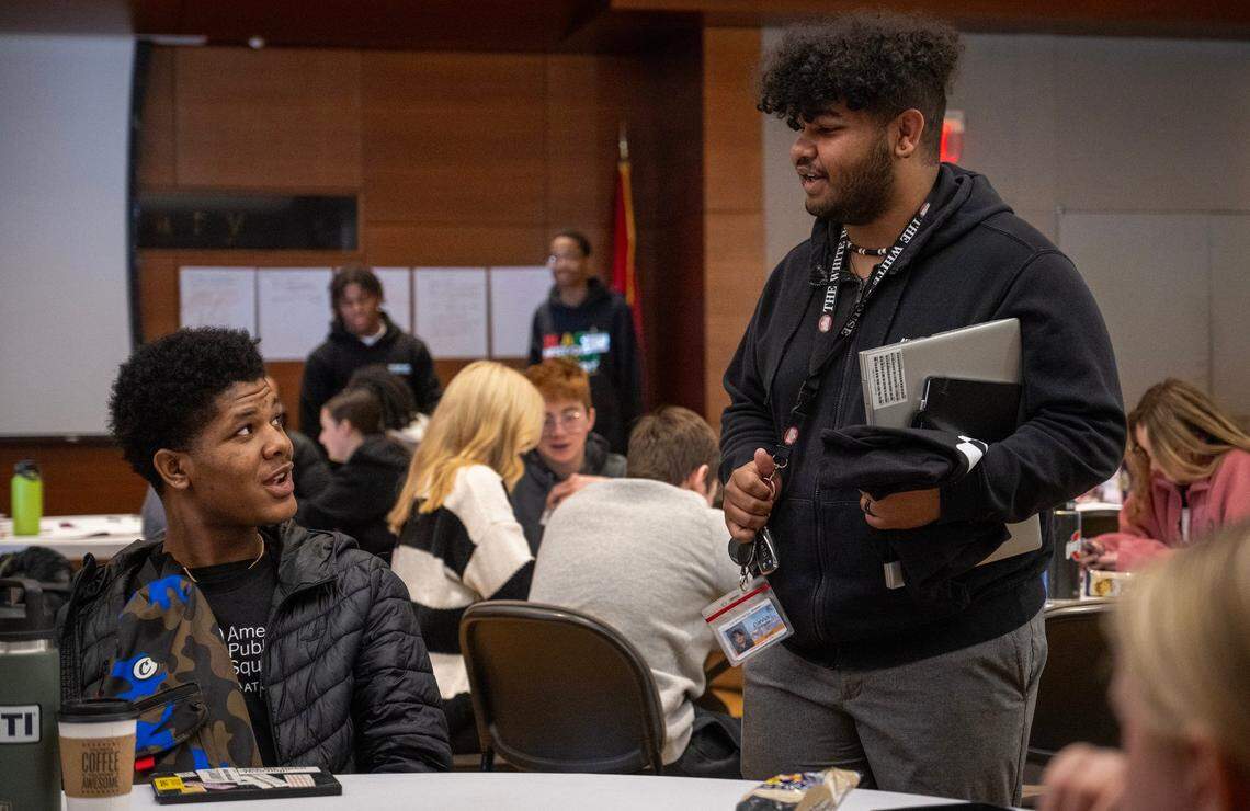 Kenon Lofton, 17, left, a student at University Academy, talks with DJ Yearwood, a youth advocate, who spoke the about KC Youth and Young Adult Commissions for the City of Kansas City during a student event with American Public Square on Wednesday, Feb. 28, 2024, at the Central Library in Downtown Kansas City. The event was a recruiting event for Yearwood who would like to get more young adults involved in civic engagement.