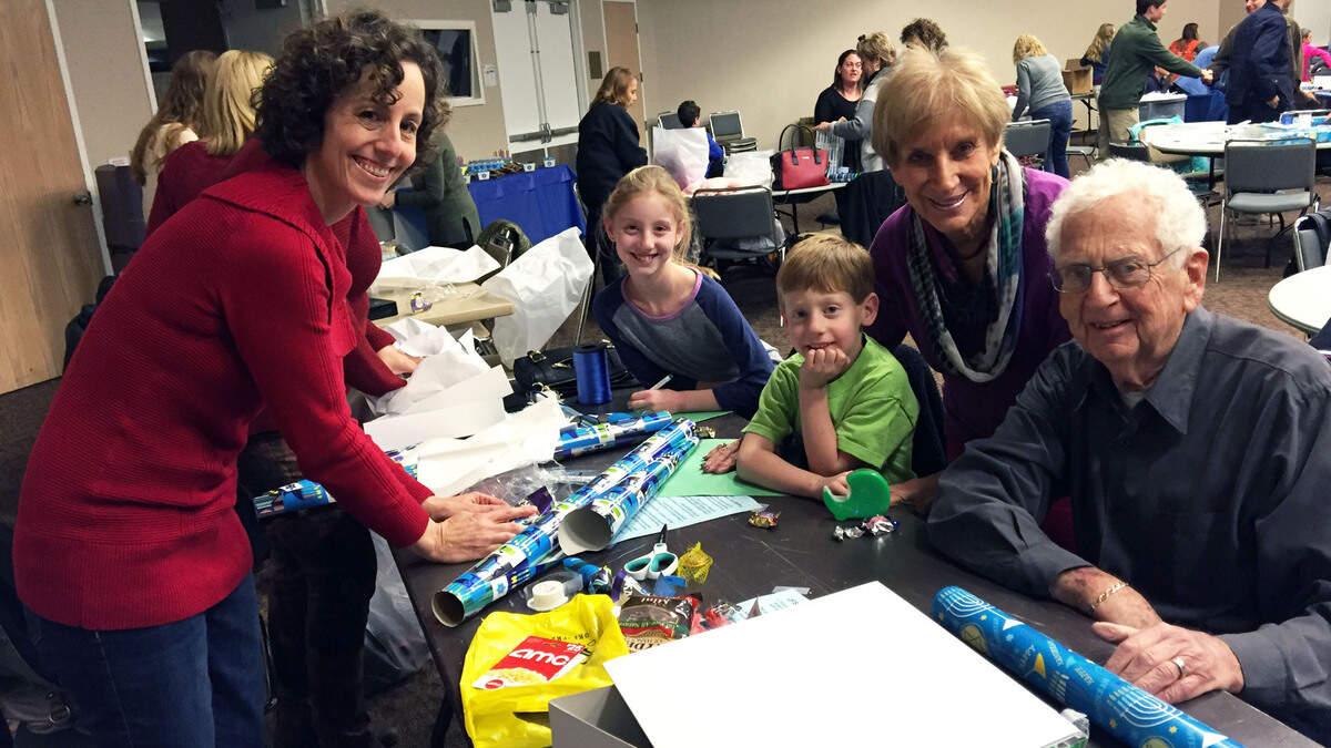 At the 2015 wrapping party, Beth Sherry helped alongside her kids, Leah Sherry and Gabe Sherry, and their grandparents, Judy Sherry and Steve Sherry.