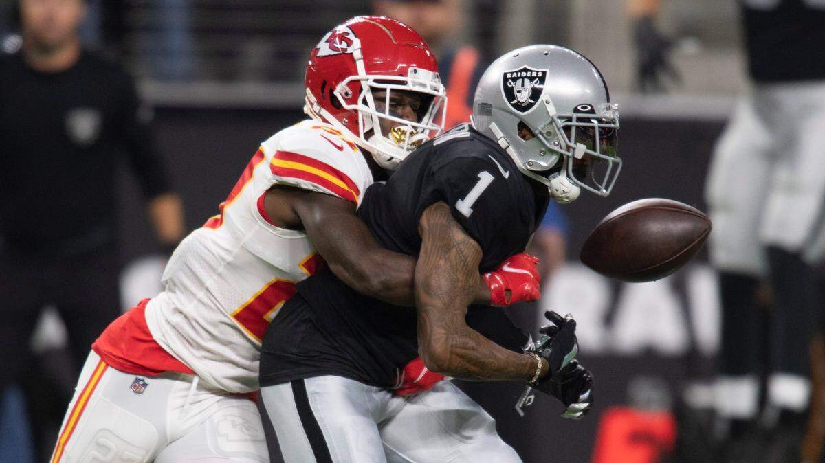 Kansas City Chiefs cornerback Rashad Fenton punches the ball from the grip of Las Vegas Raiders wide receiver DeSean Jackson during Sunday’s game.
