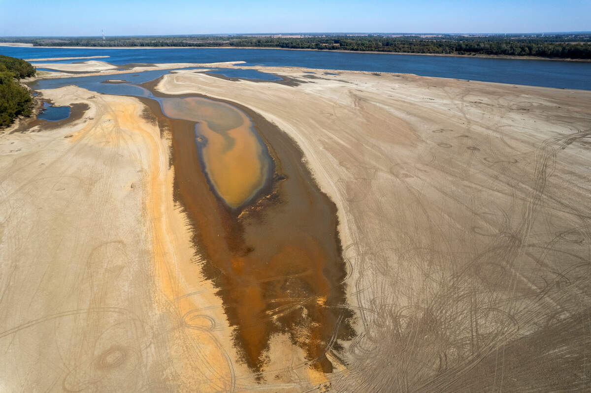 In this photo taken by a drone, the normally wide Mississippi River has been reduced to a narrow trickle Thursday, Oct. 20, 2022, near Portageville, Mo. The lack of rainfall in recent weeks has left the river approaching record low levels in areas from Missouri south through Louisiana, disrupting barge and other travel along the river.