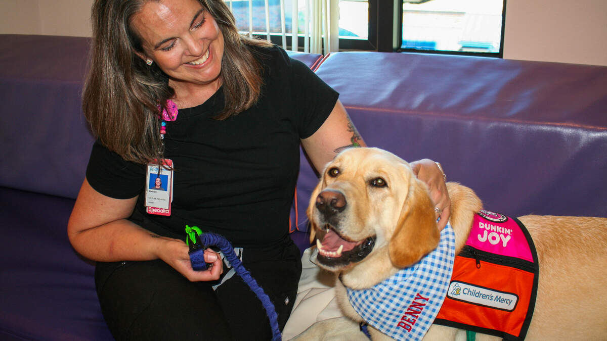 Martha Hartz, a child life specialist and dog handler, is in charge of Benny.