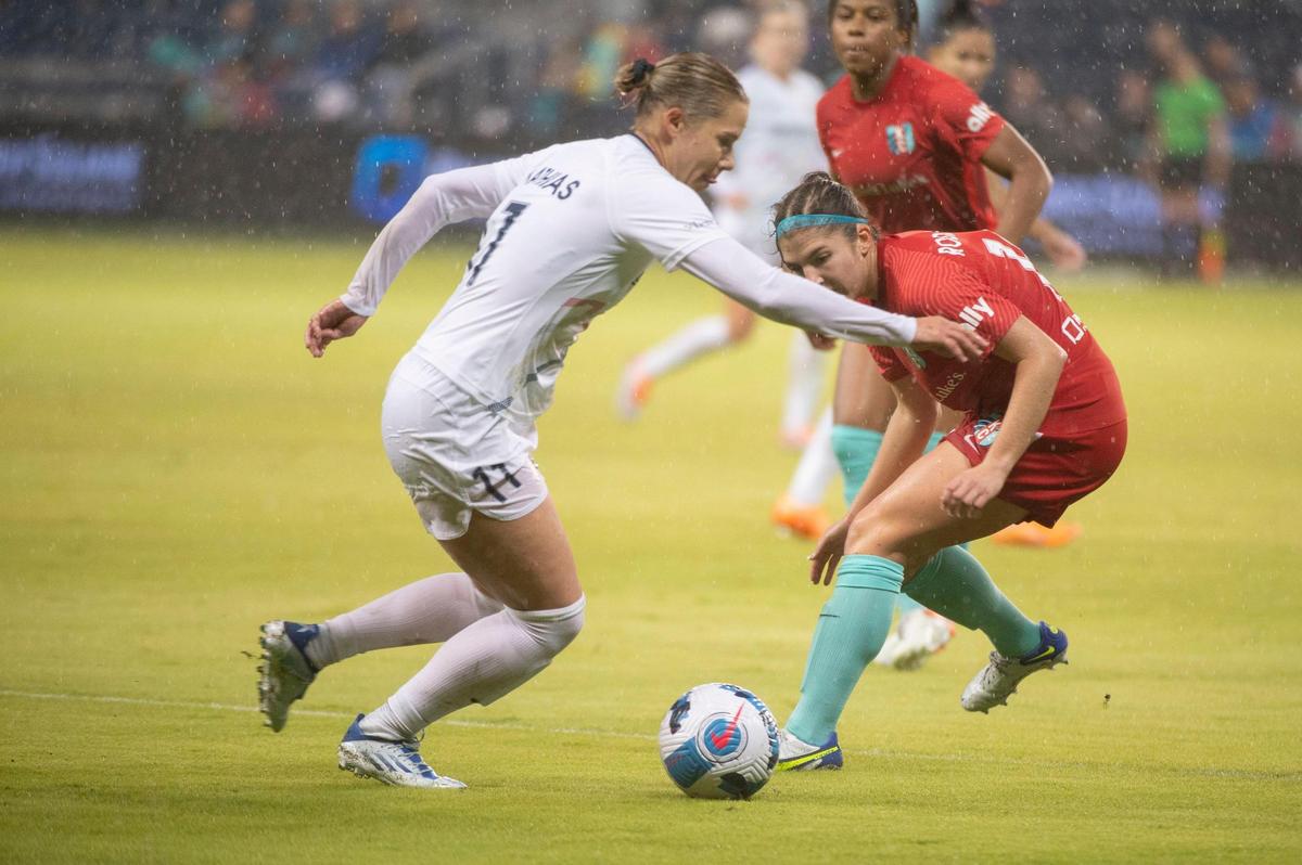 Kansas City Current defender Izzy Rodriguez, right, blocks a shot from NC Courage defender Merritt Mathias during the first half of Wednesday night’s NWSL Challenge Cup semifinal match at Children’s Mercy Park in Kansas City, Kan.