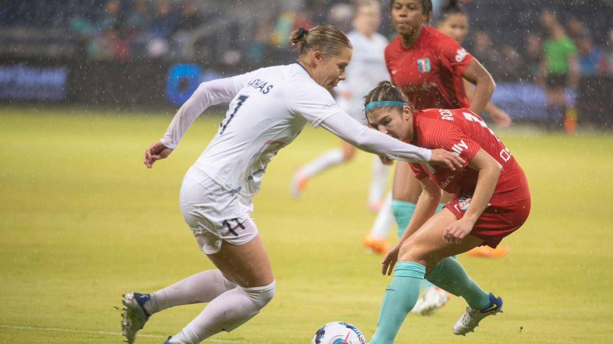 Kansas City Current defender Izzy Rodriguez, right, blocks a shot from NC Courage defender Merritt Mathias during the first half of Wednesday night’s NWSL Challenge Cup semifinal match at Children’s Mercy Park in Kansas City, Kan.