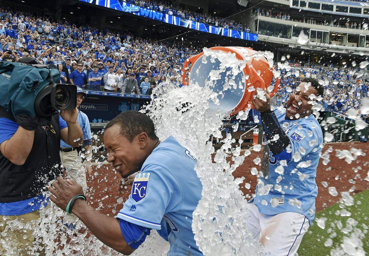 Terrance Gore is showered with ice-water by Royals teammate Salvador Perez after scoring on a wild pitch against the Minnesota Twins on April 10, 2016 at Kauffman Stadium in Kansas City.