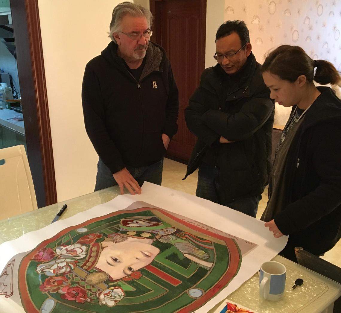 Stan Herd, architect and interpreter Ang Li (right) and a man Herd only knows as Engineer Bee look over the design.