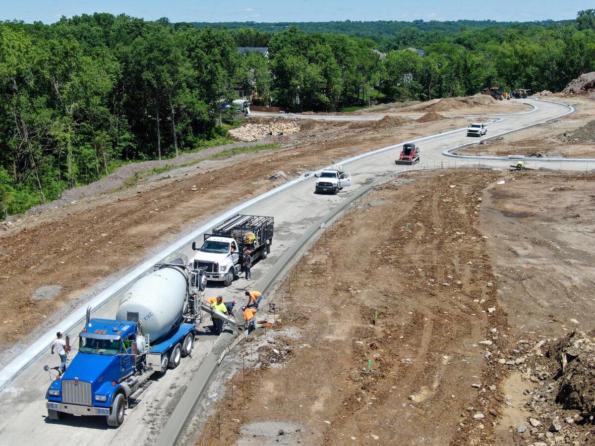 Concrete crews work on curbs for the new streets in the new Eagle Creek subdivision near West 87th Street and Penner Avenue in De Soto, Kansas.