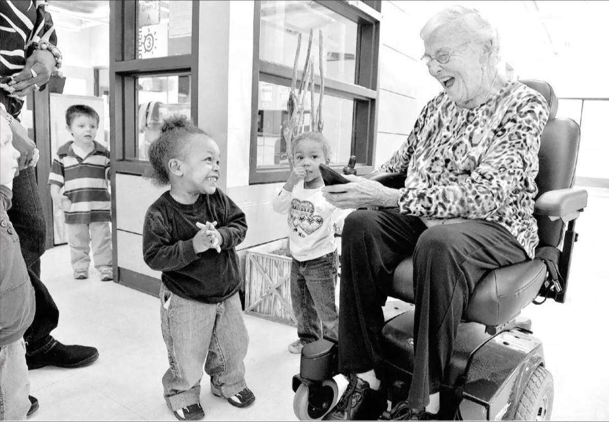 Sister Corita Bussanmas visited Operation Breakthrough, the child-care center she co-founded nearly 45 years earlier, in October 2013. She got hugs from two children.