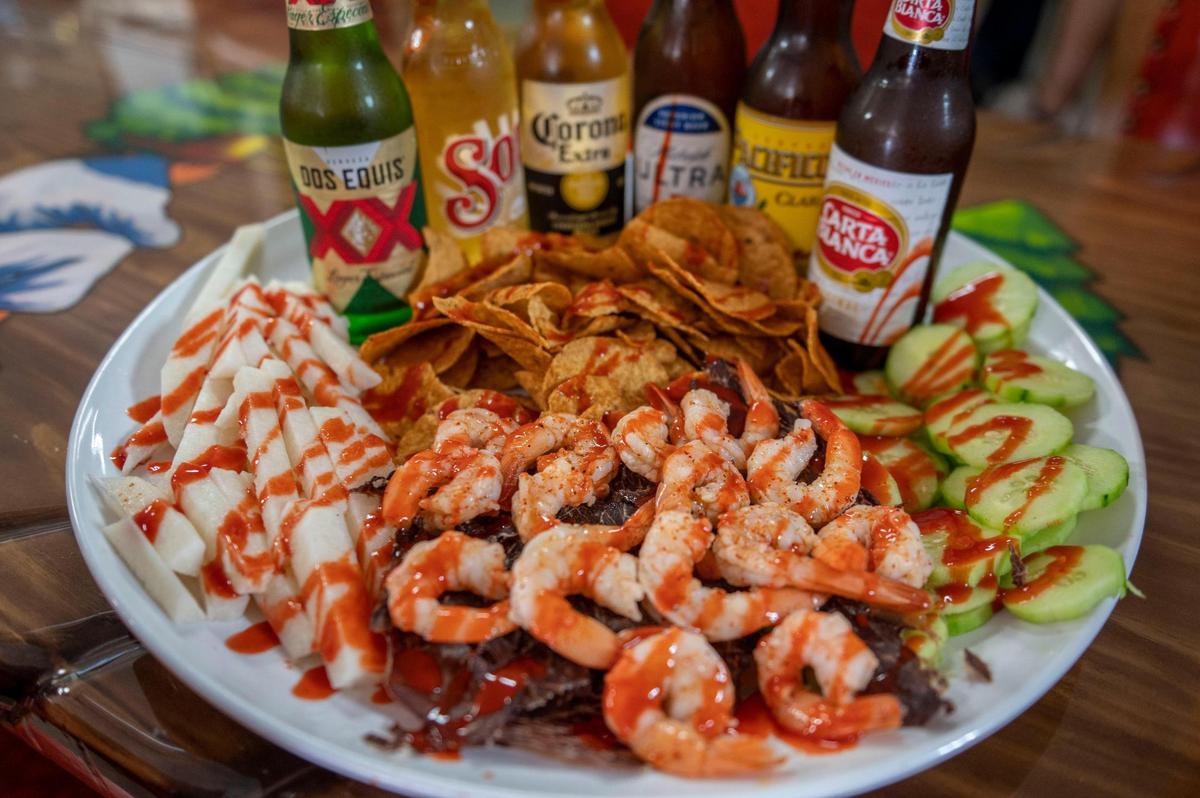 A platter of fruit, shrimp, beef jerky and chips is served with a variety of beers at Micheladas Culiacán. Owner Jenny Barraza opened this restaurant in hopes of bringing to KCK an element of Culiacan in Mexico, where she’s from.