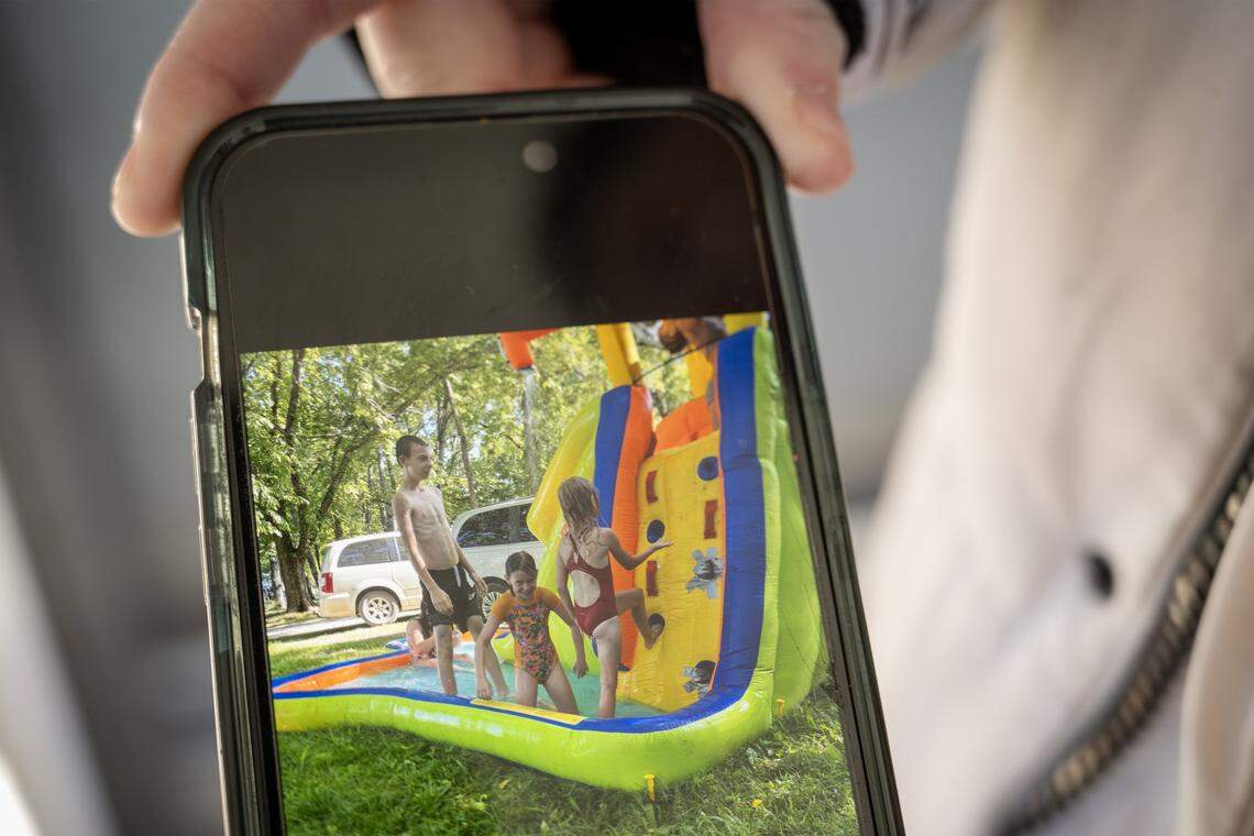 Ashlyn Clough, a close friend of the Andula family, displays a photo on her phone on Monday, Jan. 12, 2026, that shows Airen Andula, left, playing on a slide with his sister and her daughter last summer. 