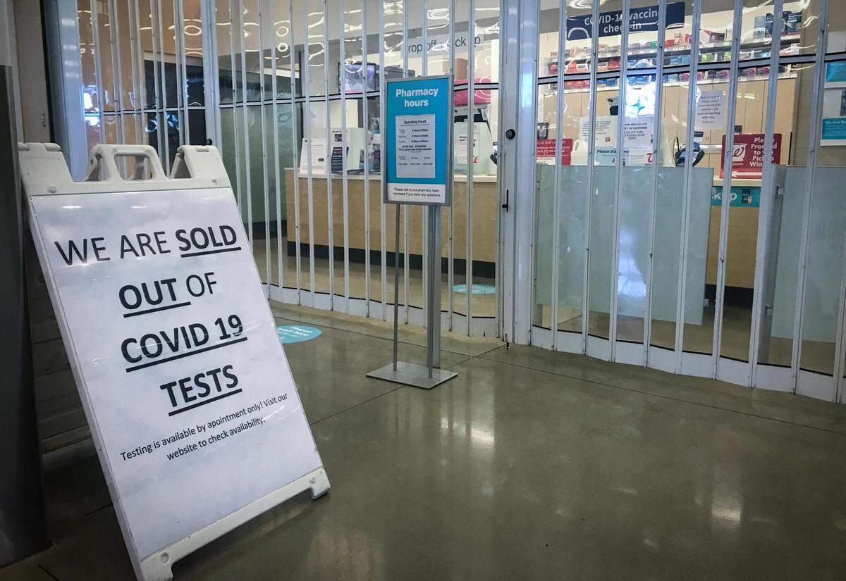 A sign at a pharmacy let customers know they were sold out of COVID-19 home test kits on Sunday, Jan. 9, 2022, in Leawood.