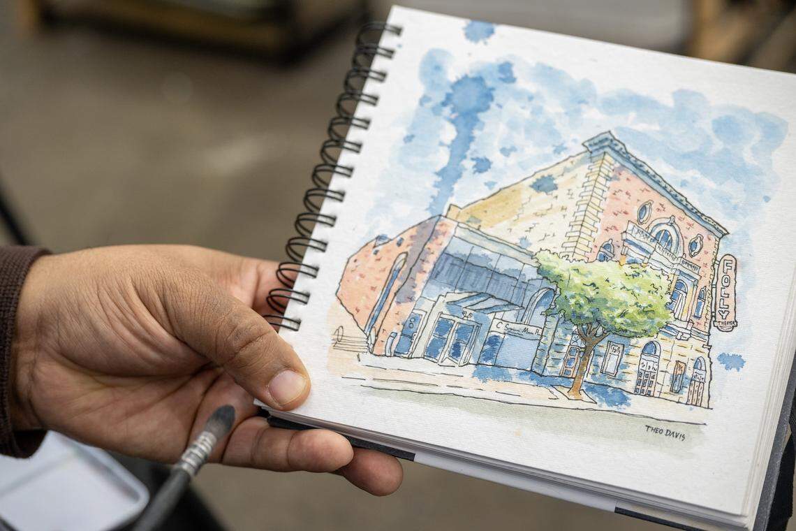 Artist Theo Davis shows a commissioned artwork created for the historic Folly Theater while speaking about his work on Tuesday, Dec. 16, 2025, in Kansas City.