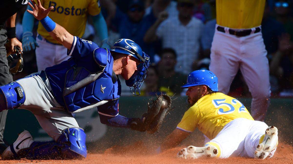 Boston Red Sox right fielder Wilyer Abreu safely slides past the stage of Kansas City Royals catcher Freddy Fermin during the third inning at Fenway Park.