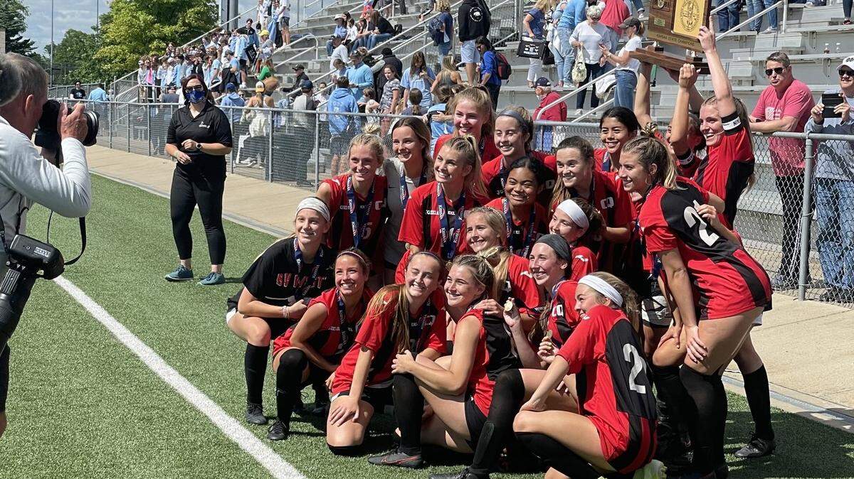 The Blue Valley West girls soccer team celebrates with the hard-earned hardware Saturday afternoon in Topeka.