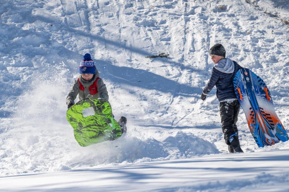 A group of kids in the Westwood neighborhood in Kansas City have some fun in the snow including some sledding, on Monday, Jan. 6, 2025.
