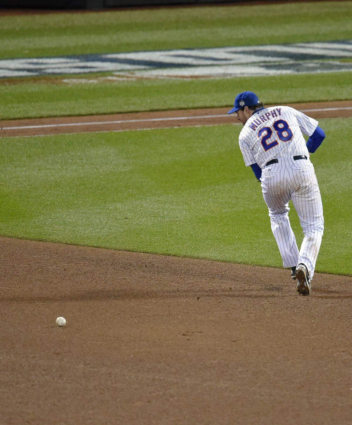 New York Mets second baseman Daniel Murphy misplays fielding a ground ball hit by Kansas City Royals first baseman Eric Hosmer in the eighth inning which allowed second baseman Ben Zobrist to score during Game 4 of the World Series on Saturday, October 31, 2015 at Citi Field in New York.