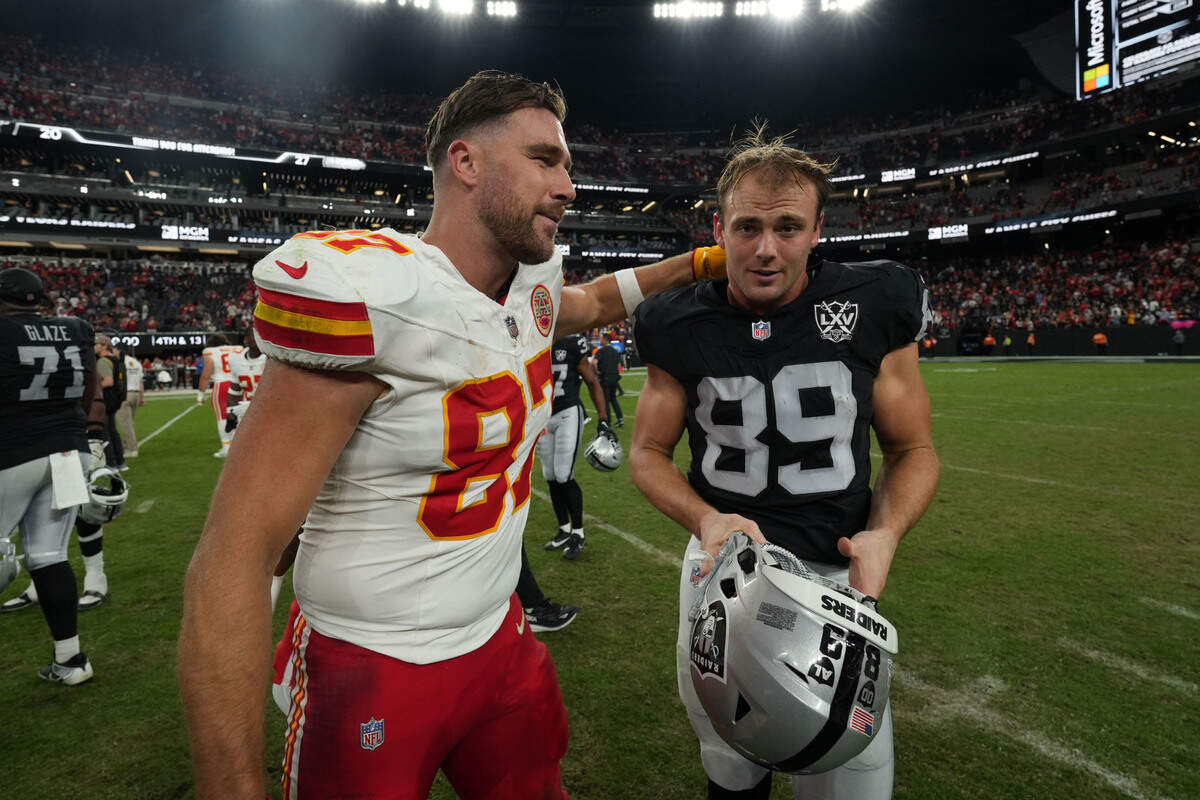 Kansas City Chiefs tight end Travis Kelce (87) and Las Vegas Raiders tight end Brock Bowers (89) interact after the game at Allegiant Stadium.