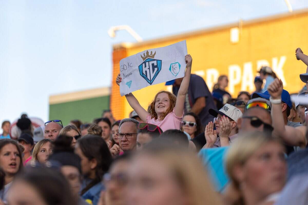 A fan holds up a sign in the stands during the KC Diamonds home opener at Legends Field on Wednesday, June 17, 2026. The KC Diamonds won 5-3 over the Florida Vibes.