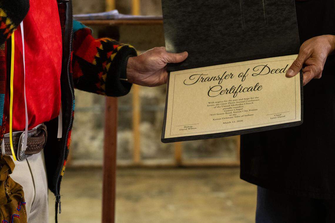 Bishop David Wilson presents the transfer of deed certificate to Chief David Lynn of the Kansas Delaware Tribe of Indians, in the basement of Grinter Chapel during a ceremony on Thursday, March 12, 2026, in Kansas City. The deed to the former church property was given back to the Kansas Delaware Tribe of Indians, Inc.