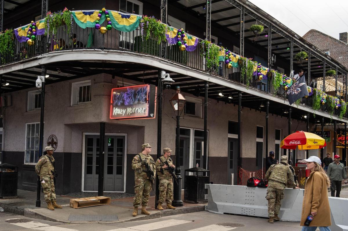 Military personnel stand guard with assault rifles and heavy barricades on Bourbon Street in New Orleans on Wednesday, Feb. 5, 2025. Law enforcement filled the famous stretch of road as the city makes preparations for Super Bowl LIX on Sunday at the Caesars Superdome.
