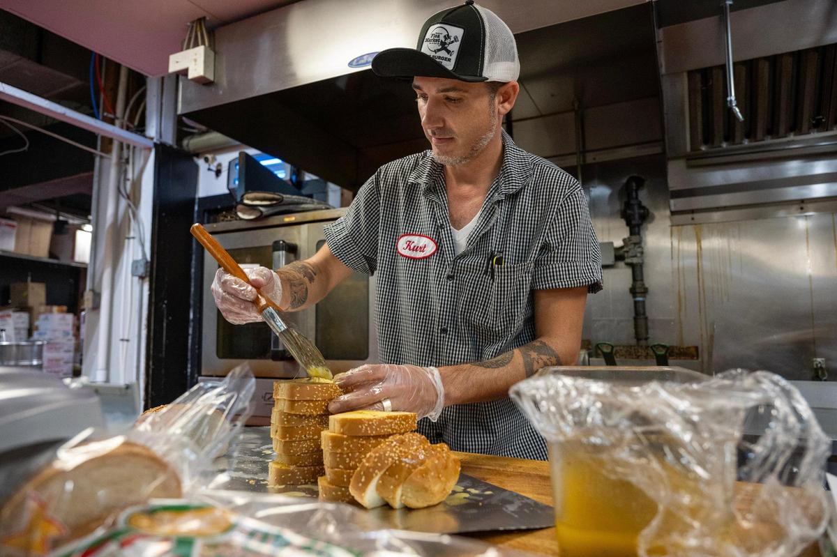 Chef Kurt Browning, who manages the school lunch orders and meal details at Westport Flea Market, prepares garlic bread on Thursday, October 24, 2024, in Kansas City. The longtime Kansas City restaurant, which does catering under Joe Joe’s Catering, generates 70 percent of its business from catering school lunches.